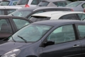 Cars parked in a busy public parking lot near Wrightsville Beach, North Carolina, during the summer season when beach parking demand is at its highest.